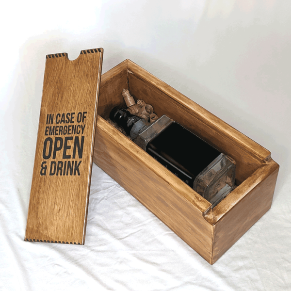 Wooden liquor box that says "In case of emergency open & drink"