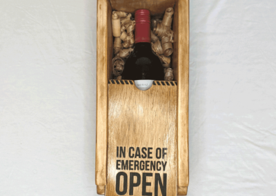 Wooden liquor box that says "In case of emergency open & drink"